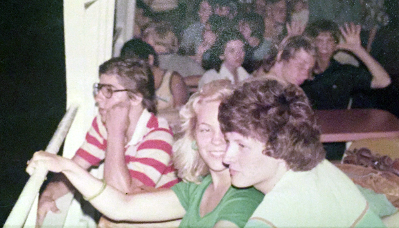 Mike Happ and Jamie Jacobs chat, while Chris Driskill enjoys the scenery during an evening cruise on Acapulco Bay.