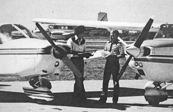 FLYIN' HIGH... Pilots Mike Happ and Kelly Langham compare flight logs after landing at Wiley Post Airfield.