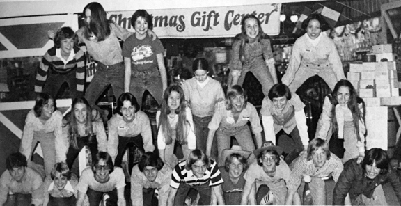 NWC workers at Hickory Farms in Shepherd Mall build a pyramid in front of the store.