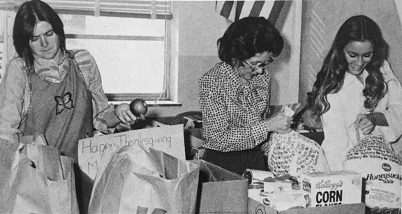 THANKSGIVING dinners are boxed by Courtesy Club sponsors Ms. Diane Noble and Ms. Maxine Housholder along with club president Tina Held.