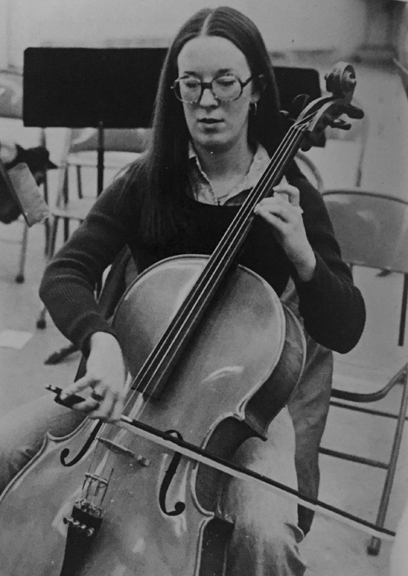 CONCENTRATING... on a difficult score, second chair celloist Linda Amick practices on a number for the spring concert.