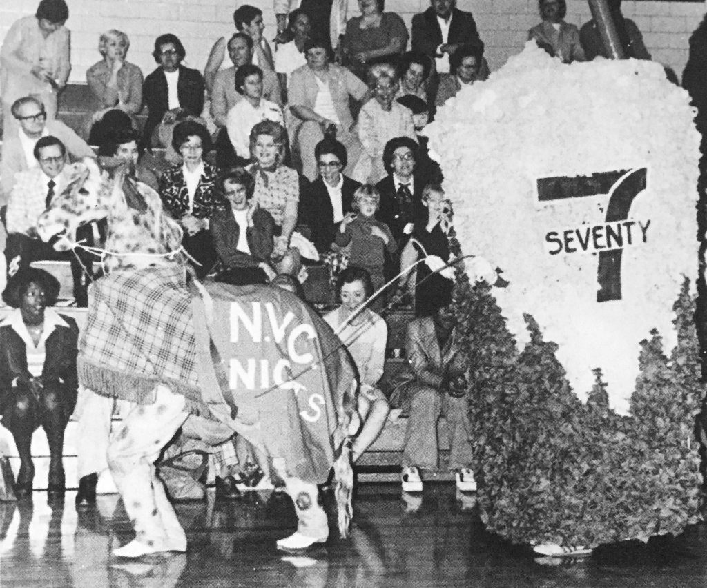 THANK HEAVENS FOR SEVENTY-SEVEN... The senior class mini-float featuring a giant Icy Drink entertains the crowd at the Homecoming Assembly.